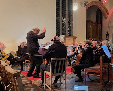 The Gwent Chamber orchestra in performance, with an animated conductor