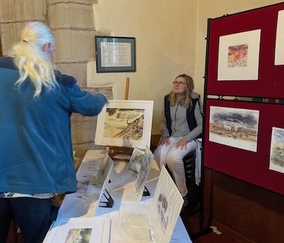 The artist with a selection of prints