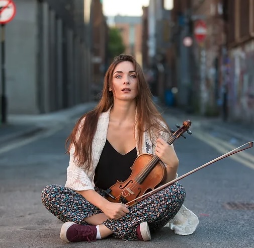 Portrait of the artist holding her violin.