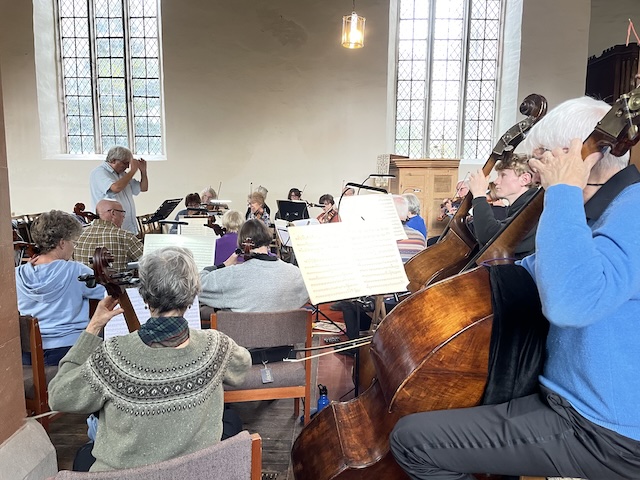 Orchestra string and basses in rehearsal.