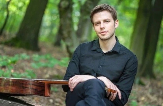 A guitarist in woodland