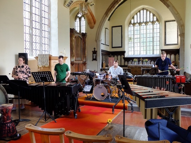 A percussion ensemble in a church settting.