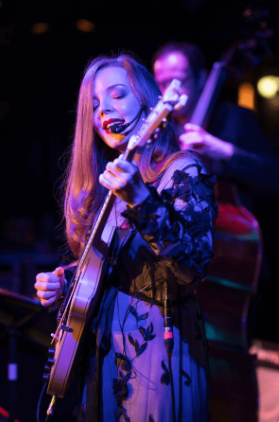 A singer/songwriter on guitar.