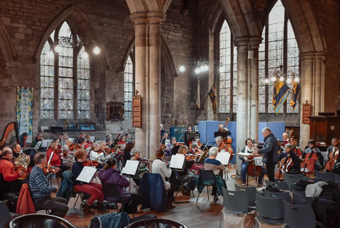 An orchestra in a church setting.